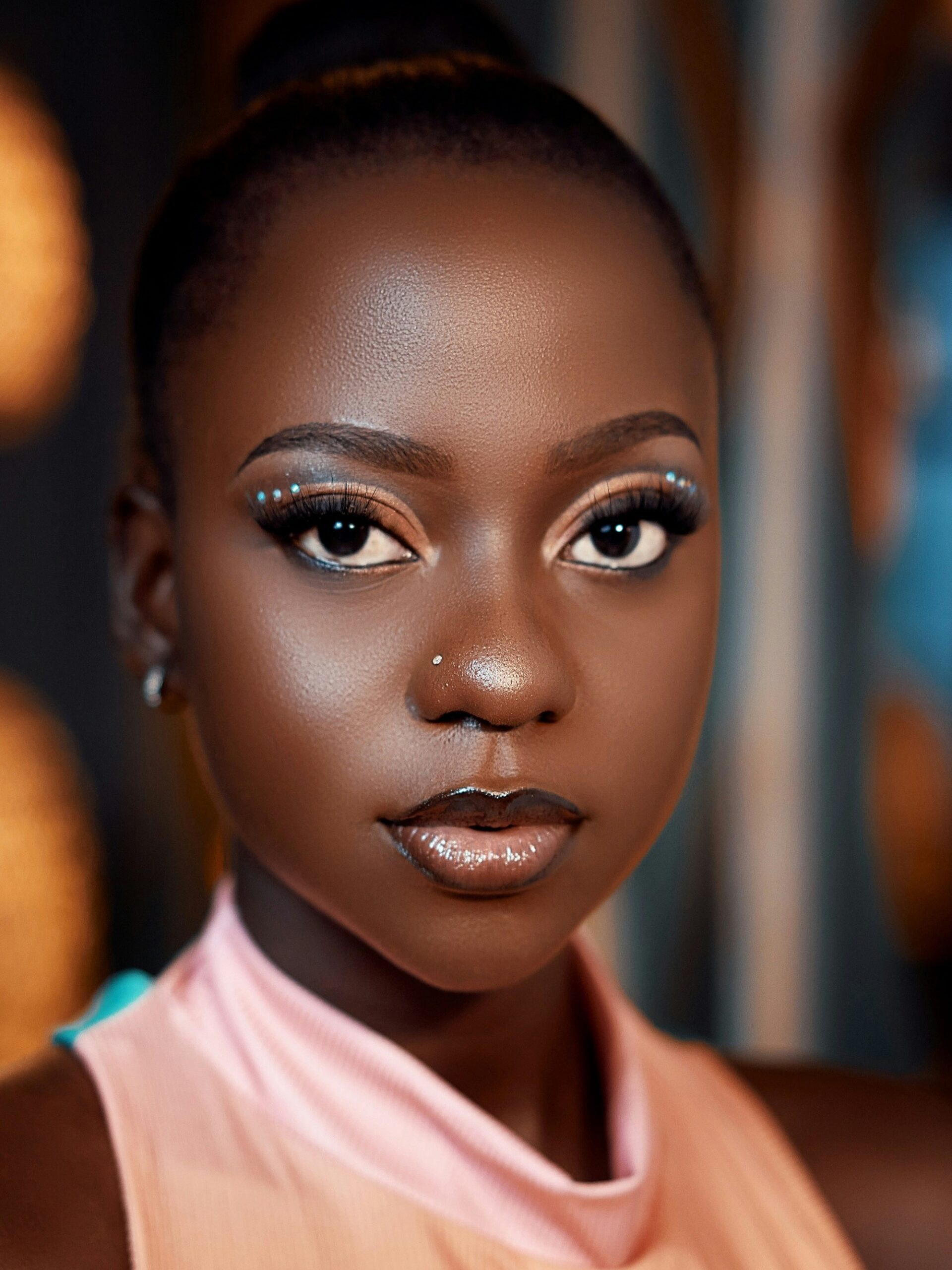 A portrait shot of a young woman with microblading on her brows wearing a glamorous make-up look